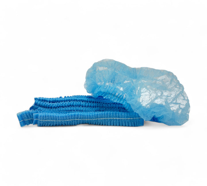 Blue crinkled mop cap hair nets in cartons for compliant head protection in factories and food production