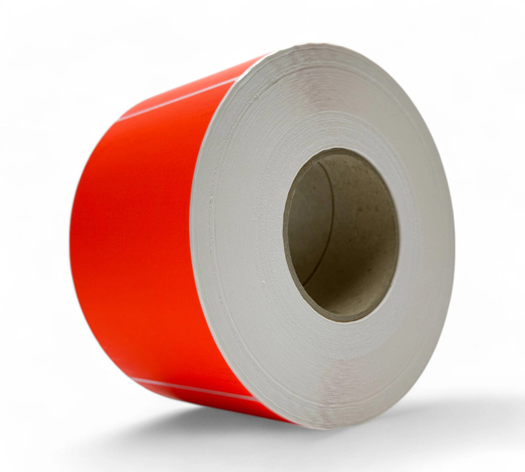 Red 100 x 150mm thermal transfer labels shown rolled and ready for urgent product tagging and priority shipping