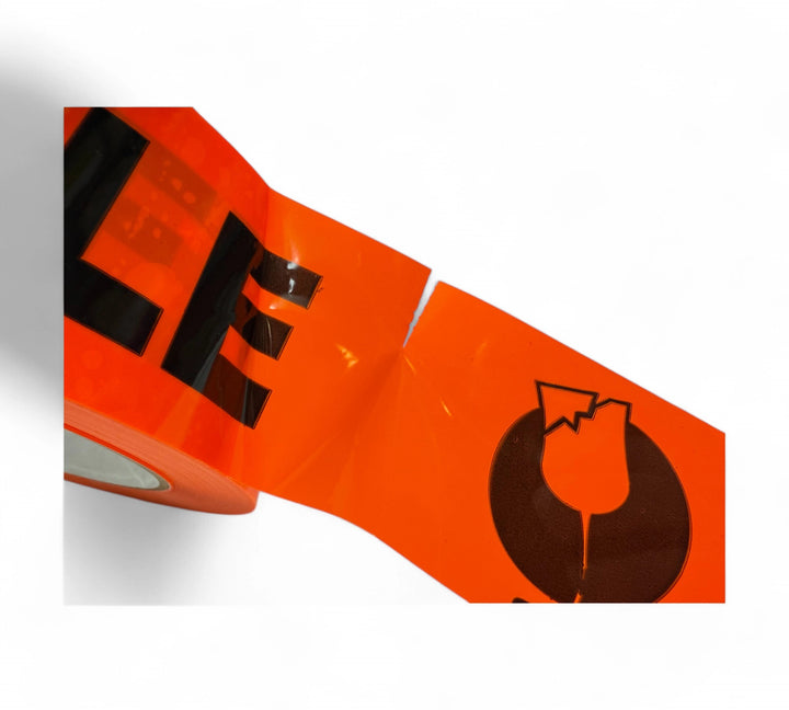 Close-up of perforated Fragile label 48mm x 250mm in black on fluro orange, showing tear line for easy separation