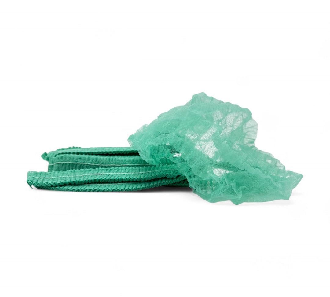 Green crinkled mop cap hair nets displayed for workplace hygiene in industrial or clean zone use