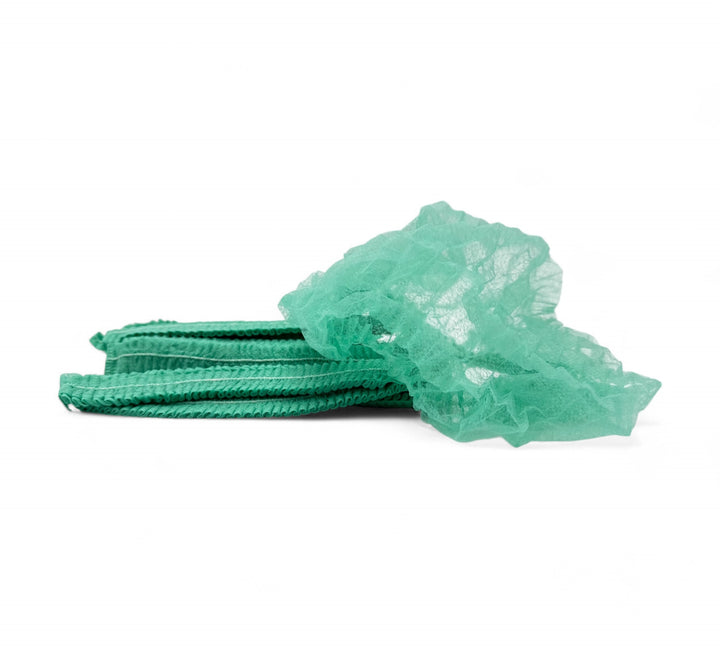 Green crinkled mop cap hair nets displayed for workplace hygiene in industrial or clean zone use