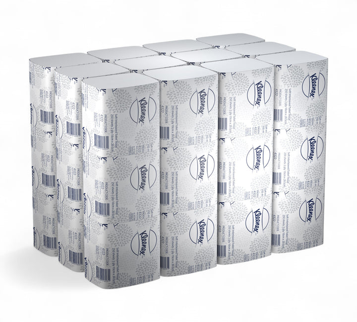 Bulk stacked view of KLEENEX Soft Interleaved Toilet Tissue (4322), displaying individually wrapped packs with branded grey and white floral pattern, arranged for visualising full carton quantity.
