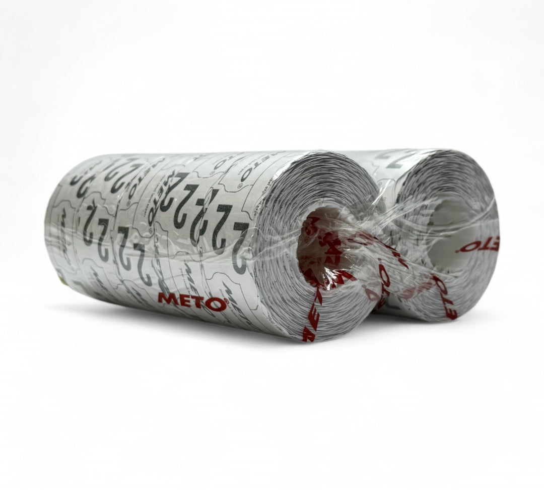Plain white 26 x 16mm Meto label rolls shown compactly stacked for price labelling in retail and inventory systems