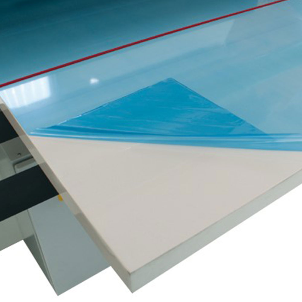 Blue surface protection film rolled onto flat board with automated film application system in manufacturing line