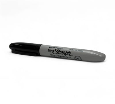 Sharpie marker fine point black displayed capped with bold permanent ink for writing on cardboard plastic or metal