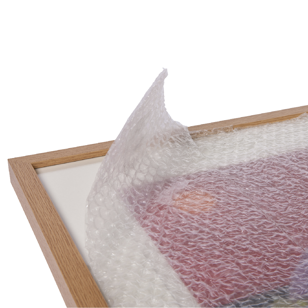 Protective bubble wrap covering a wooden frame for safe packaging