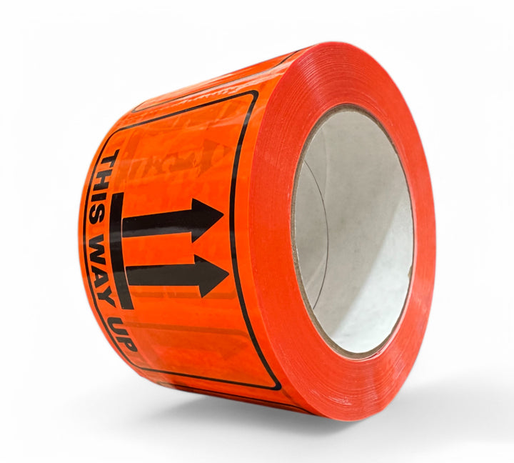 This Way Up Rip A Label 72 x 100mm x 50m black on fluro orange shown with arrows for orientation of cartons and pallets