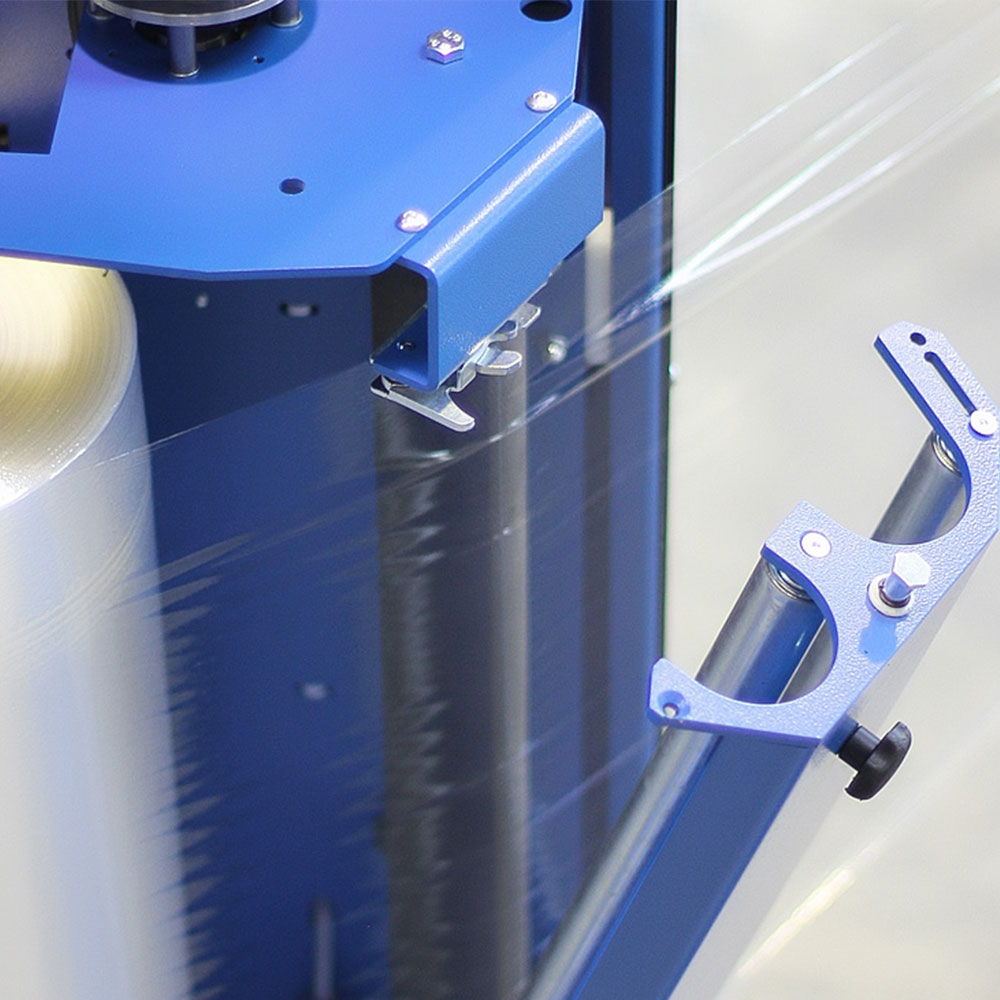 PSE 2000 stretch wrapper carriage with film roll loaded, showing precision-engineered tension rollers for consistent wrap force
