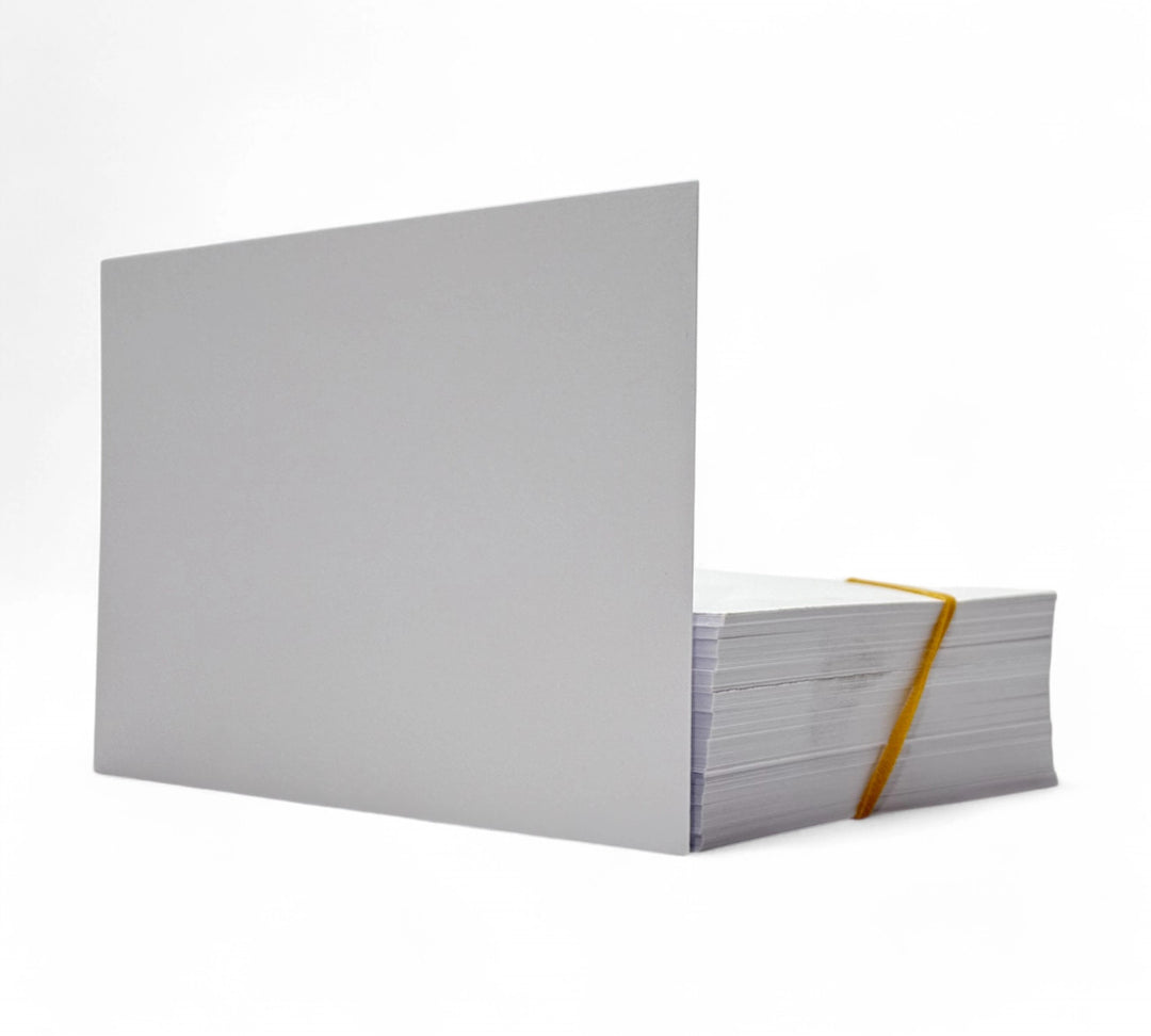 White 99 x 148mm direct thermal cards in 250gsm stock shown stacked for barcode cards and shipping inserts