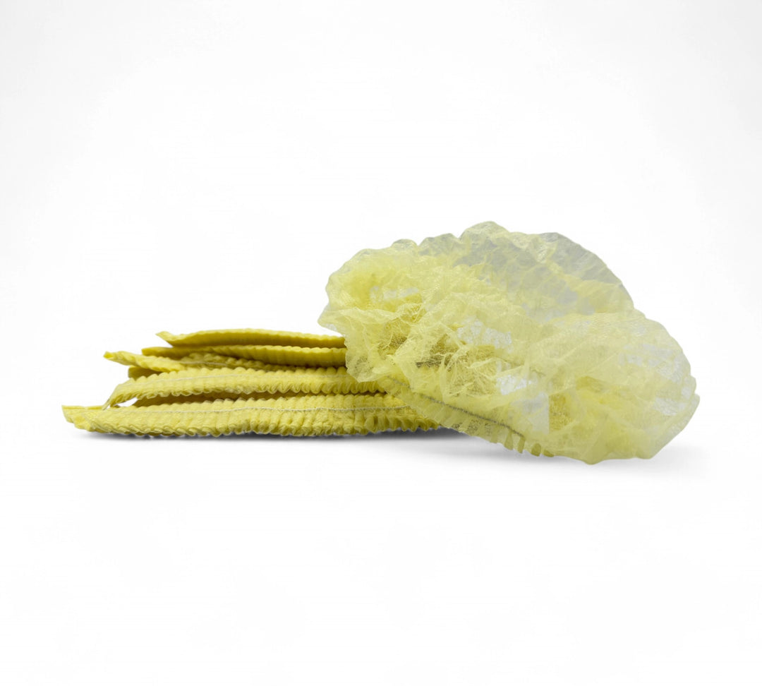 Yellow crinkled mop cap hair nets displayed in cartons for high visibility and colour separation in workplace settings