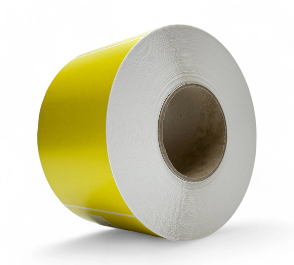 Yellow 103 x 150mm direct thermal labels shown rolled with perforation for retail or production-based barcode systems