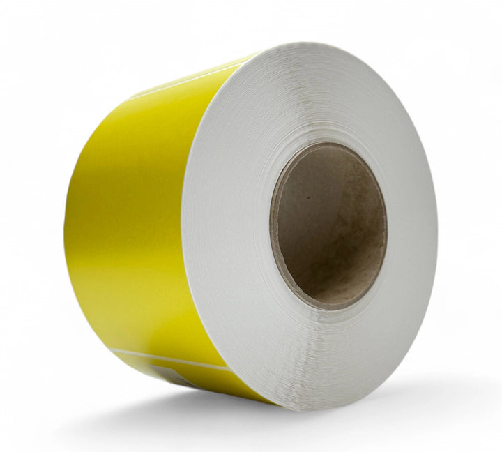Yellow 103 x 150mm direct thermal labels shown rolled with perforation for retail or production-based barcode systems